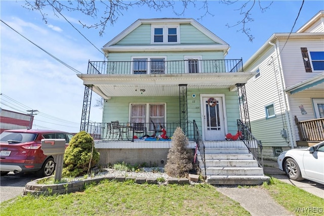 view of front of home featuring covered porch and a balcony