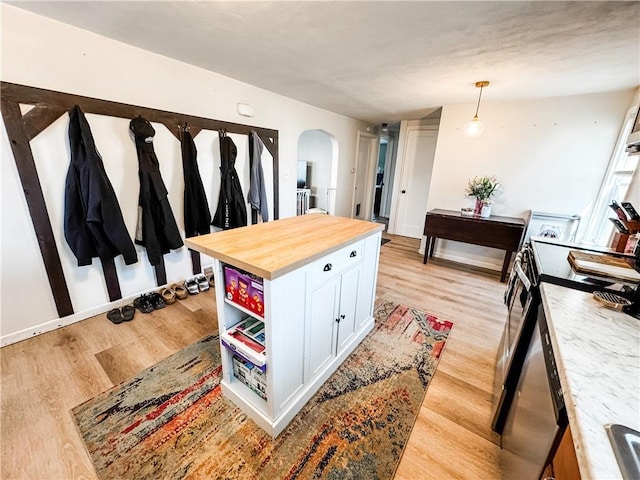 117 Raphael Ave, Salina, NY 13211 - kitchen featuring arched walkways, stainless steel range with electric cooktop, wooden counters, white cabinets, and light wood-type flooring