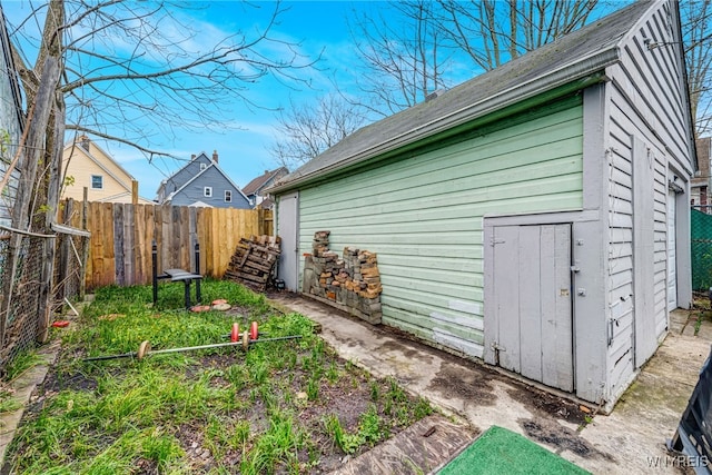 exterior space featuring roof with shingles and fence
