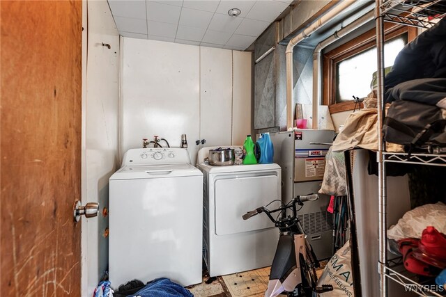 clothes washing area with laundry area and washer and clothes dryer