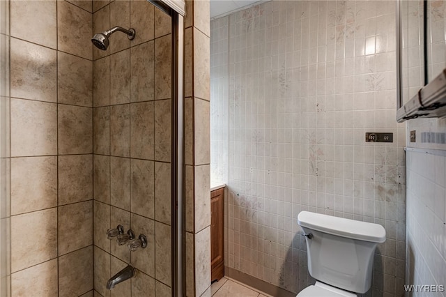 bathroom featuring toilet, tile walls, and tile patterned floors