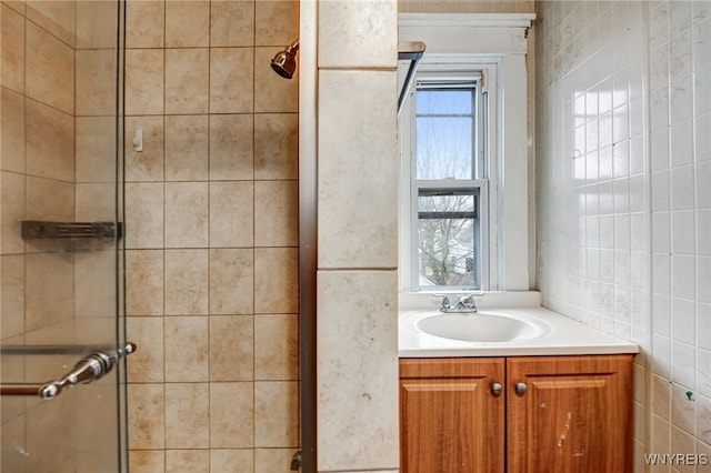 bathroom featuring a shower stall, vanity, and plenty of natural light