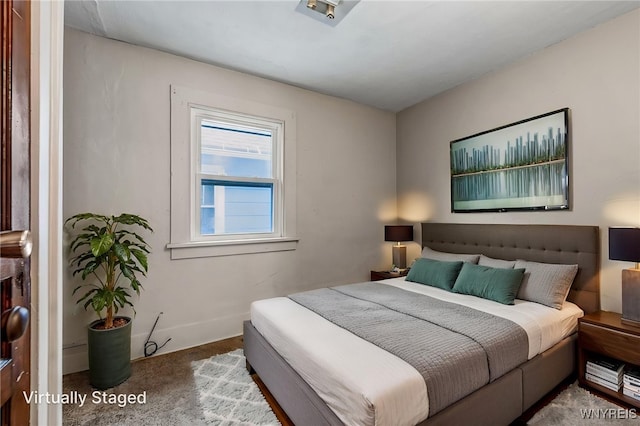 bedroom featuring carpet and baseboards