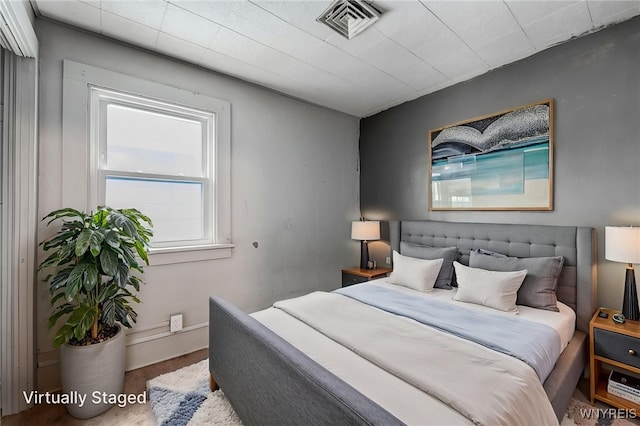 bedroom with visible vents and carpet