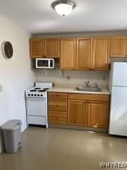 625 22nd St, Niagara Falls, NY 14301 - kitchen featuring a sink, light countertops, brown cabinetry, and white appliances