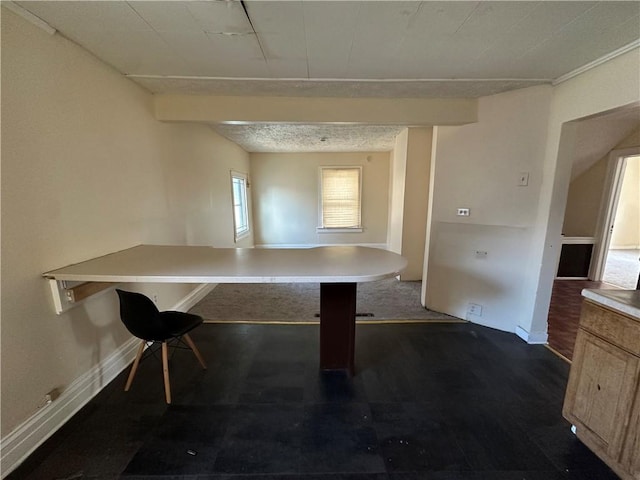unfurnished dining area featuring baseboards and dark wood-type flooring