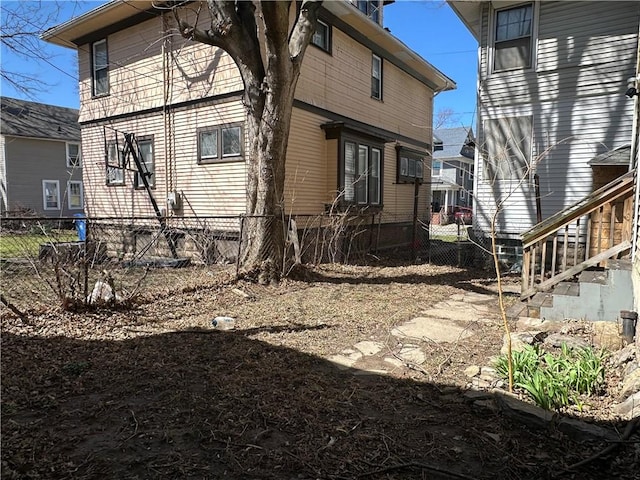rear view of house featuring fence