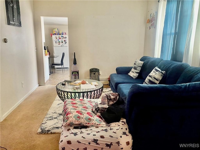 living area featuring baseboards, baseboard heating, and light carpet
