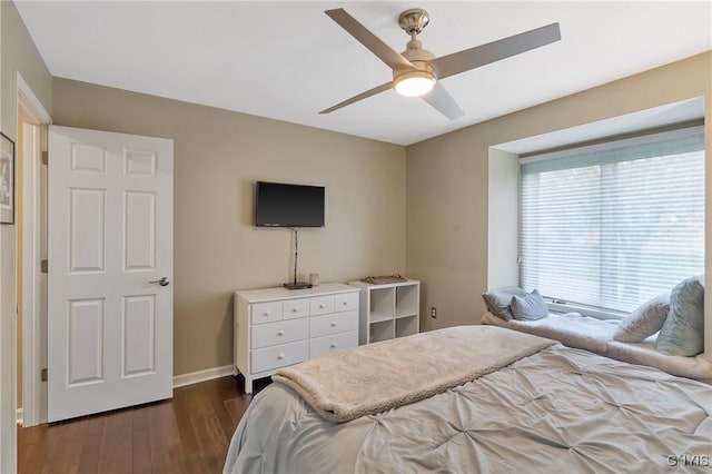 bedroom featuring a ceiling fan, baseboards, and dark wood finished floors