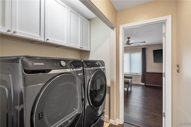 laundry area featuring cabinet space, ceiling fan, baseboards, dark wood-style floors, and washer and clothes dryer