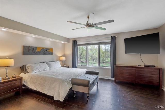 bedroom featuring a ceiling fan, baseboards, and hardwood / wood-style flooring