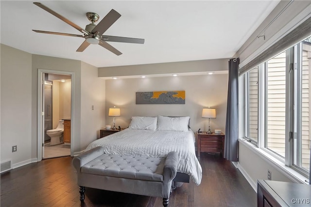 bedroom featuring baseboards, visible vents, multiple windows, and hardwood / wood-style floors