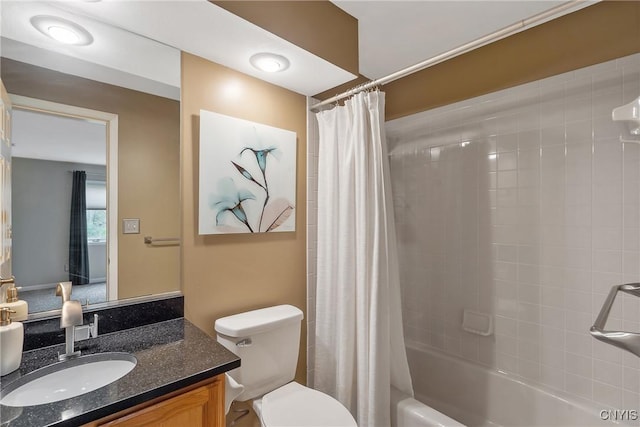 bathroom featuring toilet, shower / tub combo with curtain, and vanity
