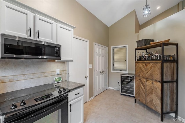 kitchen with white cabinetry, stainless steel microwave, black / electric stove, wine cooler, and backsplash