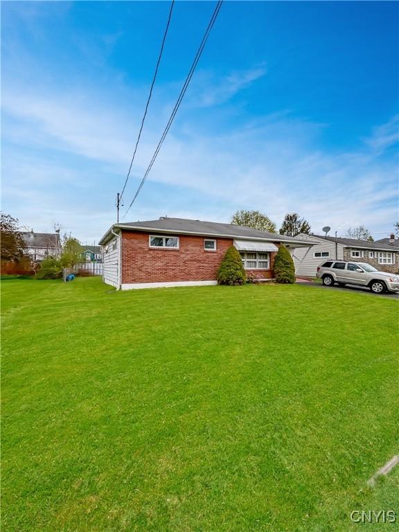 view of front of house with brick siding and a front yard