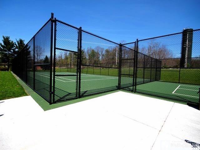 view of tennis court featuring fence