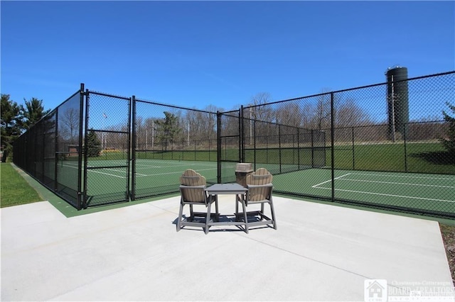 view of tennis court featuring fence