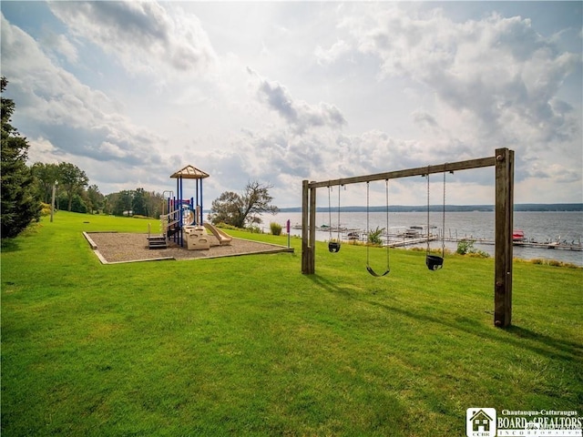 communal playground featuring a yard and a water view
