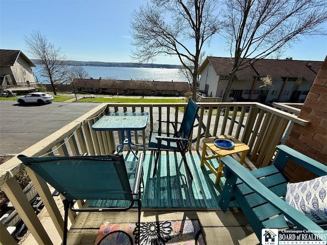 wooden deck featuring a water view