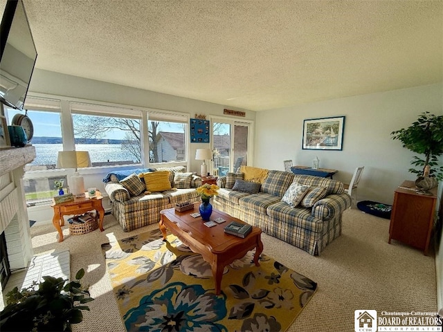 carpeted living room with a textured ceiling and a fireplace