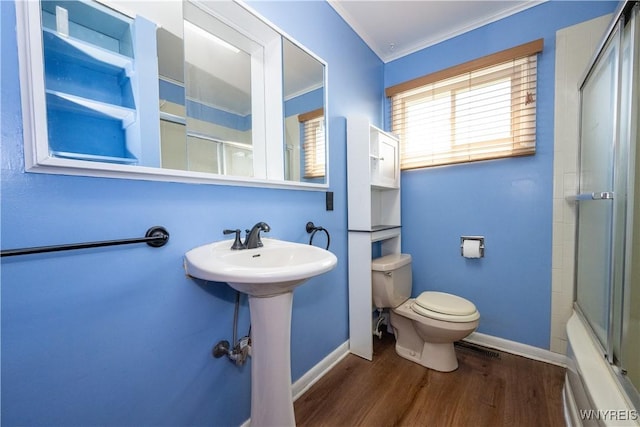 full bathroom with baseboards, ornamental molding, wood finished floors, and toilet