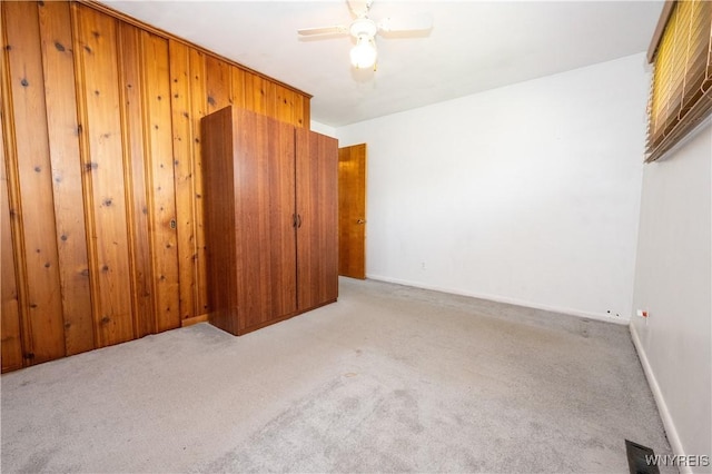 unfurnished bedroom featuring a closet, ceiling fan, carpet flooring, and visible vents