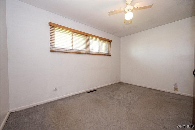 empty room featuring baseboards, carpet flooring, a ceiling fan, and visible vents
