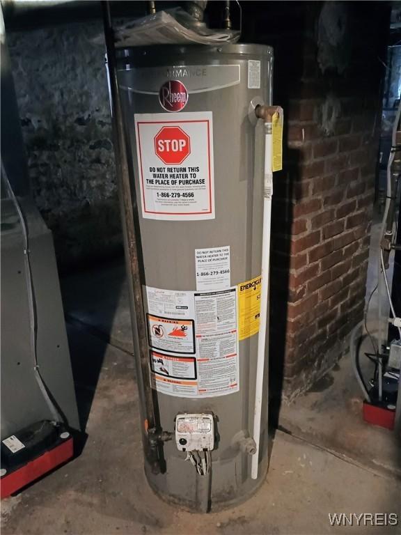 utility room featuring water heater