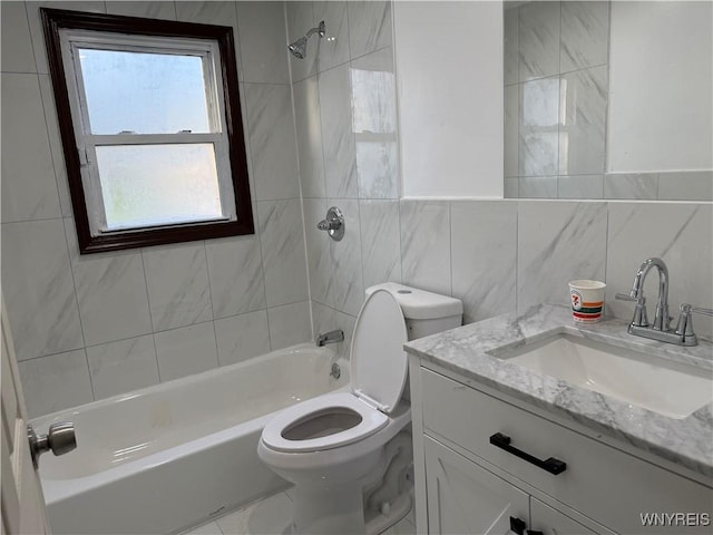 bathroom featuring tile walls, toilet, tub / shower combination, and vanity