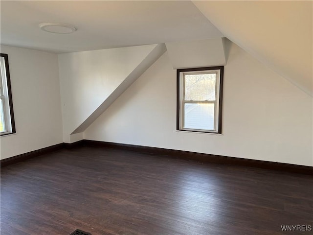 additional living space featuring lofted ceiling, wood finished floors, and baseboards