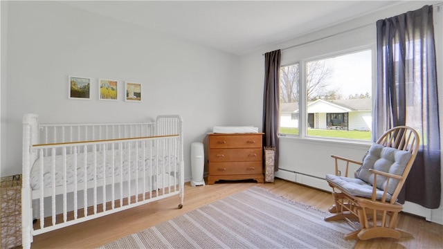 bedroom with multiple windows and wood finished floors