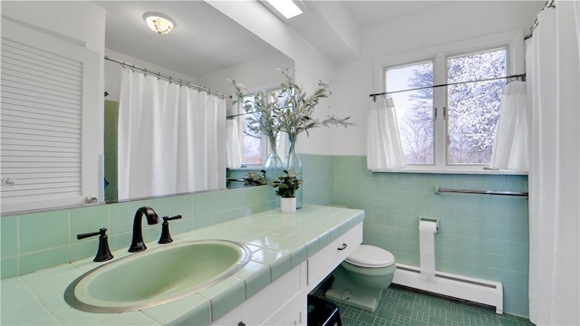 full bathroom with tile patterned floors, baseboard heating, toilet, and a healthy amount of sunlight