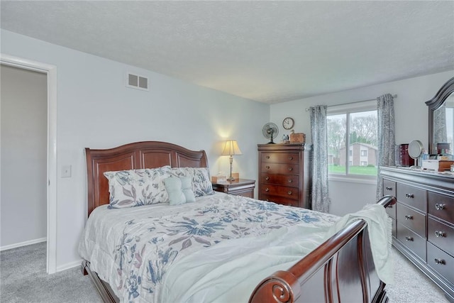 bedroom featuring visible vents, light carpet, and baseboards