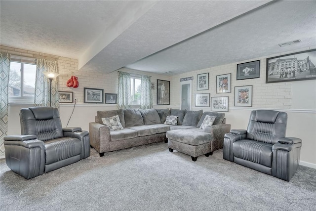 carpeted living area with visible vents, a healthy amount of sunlight, and a textured ceiling