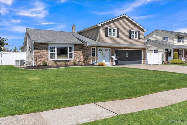 view of front of property with a chimney, fence, driveway, and stone siding