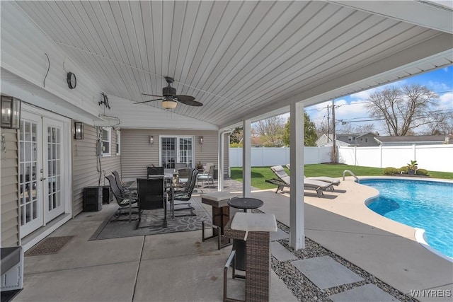 view of patio featuring ceiling fan, a fenced in pool, french doors, and a fenced backyard