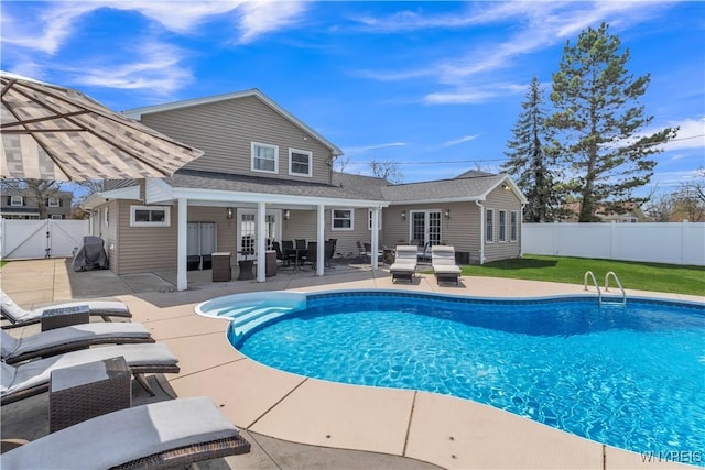 view of swimming pool featuring a fenced in pool, a fenced backyard, a patio area, and french doors
