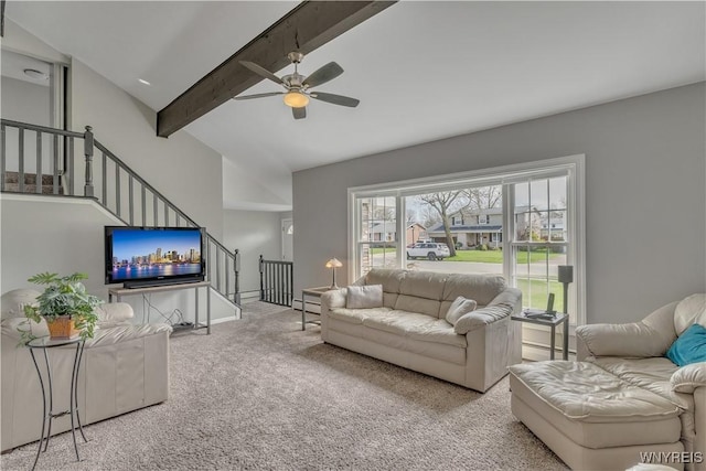 carpeted living area with a ceiling fan, lofted ceiling with beams, baseboard heating, and stairway