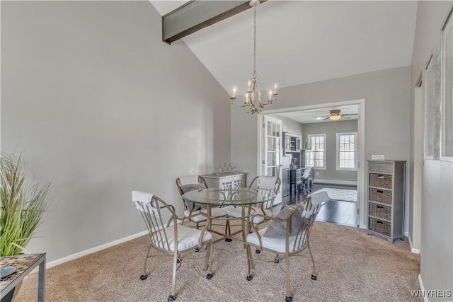 carpeted dining room featuring baseboards, beamed ceiling, ceiling fan with notable chandelier, and high vaulted ceiling