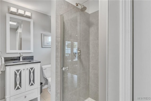 bathroom featuring vanity, tile patterned flooring, a shower stall, and toilet