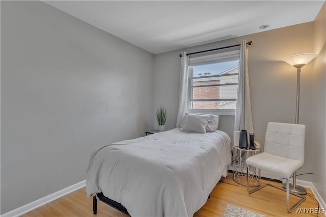 bedroom featuring light wood-style floors and baseboards