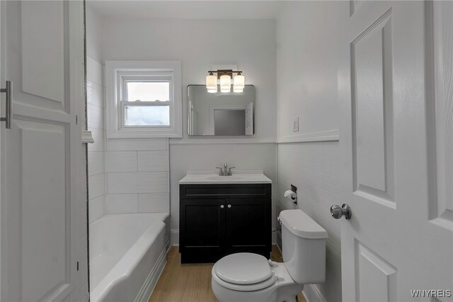 bathroom featuring toilet, wood finished floors, and vanity