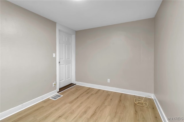 unfurnished room with baseboards, visible vents, and light wood-style flooring