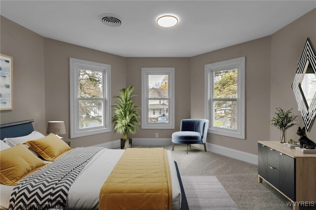 carpeted bedroom featuring baseboards and visible vents