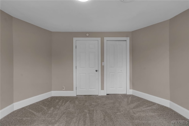 unfurnished bedroom with a closet, baseboards, and carpet floors