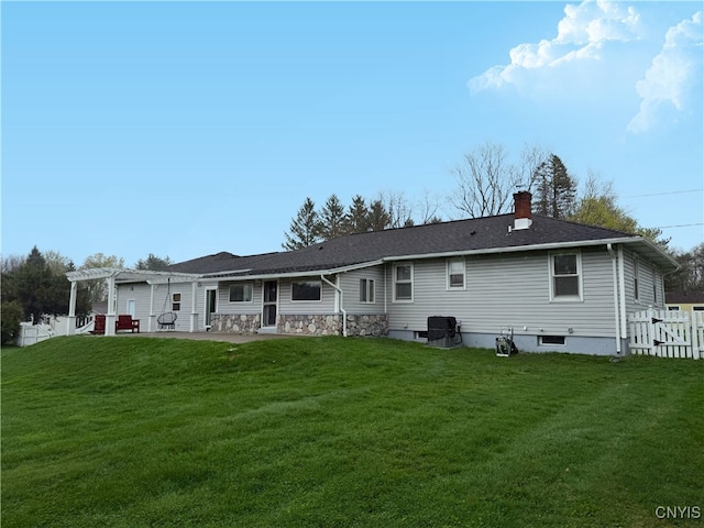 back of house featuring a pergola, a chimney, central AC unit, a patio area, and a lawn