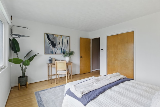 bedroom with baseboards and light wood-style flooring