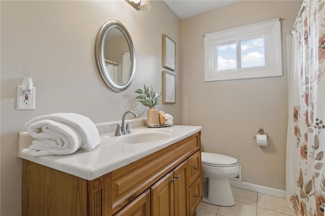 bathroom with vanity, baseboards, tile patterned floors, and toilet