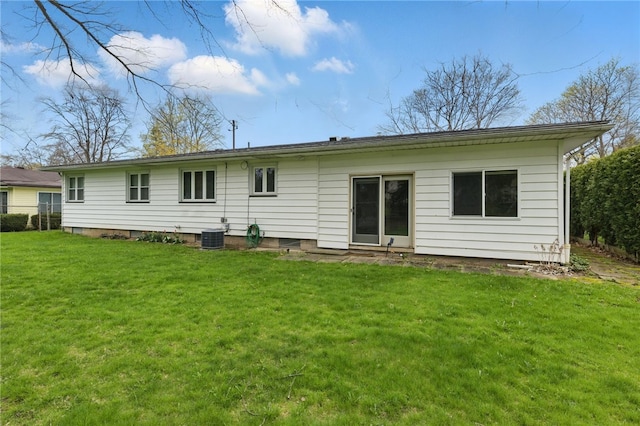 back of house featuring a yard and central AC unit