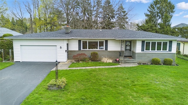 ranch-style house with an attached garage, a chimney, driveway, and a front lawn